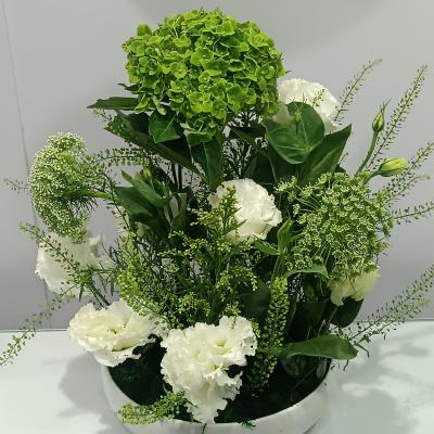 Vase Plate vase with green and white flowers